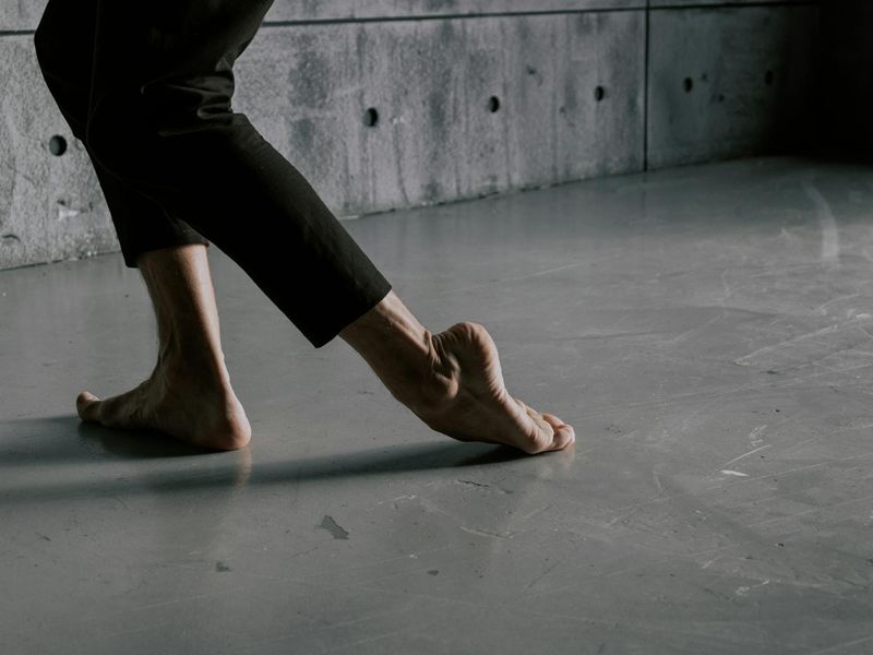 Detailed close-up of a person performing a smooth floor exercise.