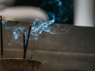 Incense stick smoke in a peaceful indoor setting.